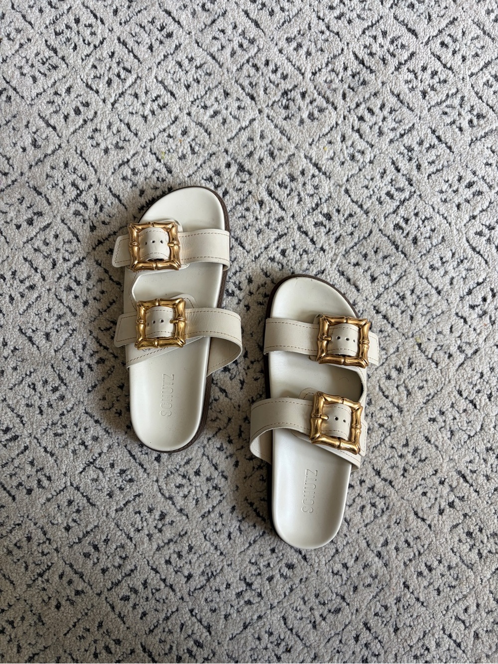 Women’s Schutz Enola White Slide Sandals with Decorative Gold Buckles - Picture 2 of 5